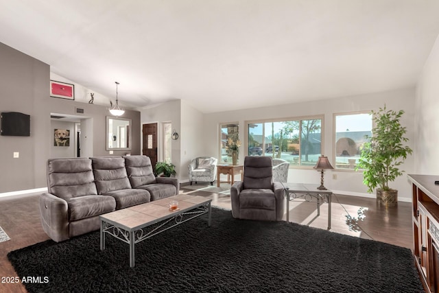 living room featuring lofted ceiling and hardwood / wood-style floors