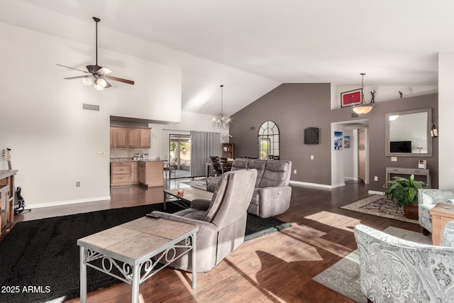 living room featuring dark wood-type flooring, ceiling fan with notable chandelier, and high vaulted ceiling