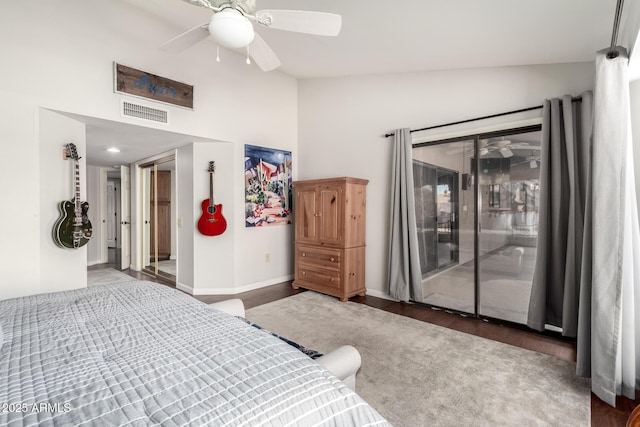 bedroom featuring lofted ceiling, dark hardwood / wood-style flooring, access to outside, and ceiling fan