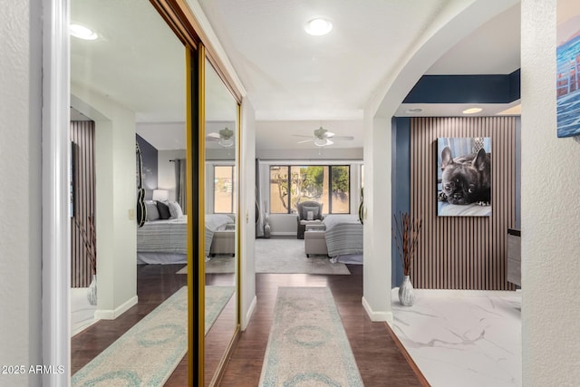 hallway with dark hardwood / wood-style floors