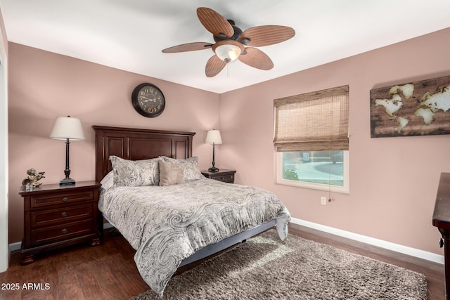 bedroom with dark hardwood / wood-style flooring and ceiling fan