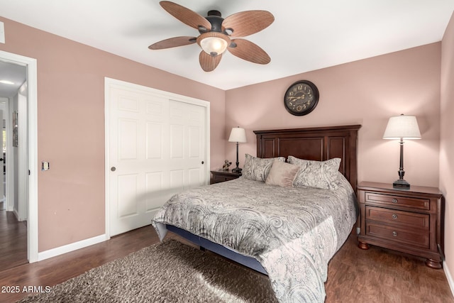 bedroom with dark wood-type flooring, a closet, and ceiling fan