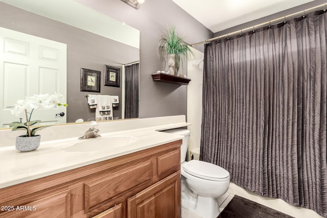 bathroom featuring vanity, tile patterned flooring, and toilet