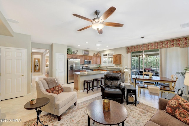 tiled living room with ceiling fan and sink