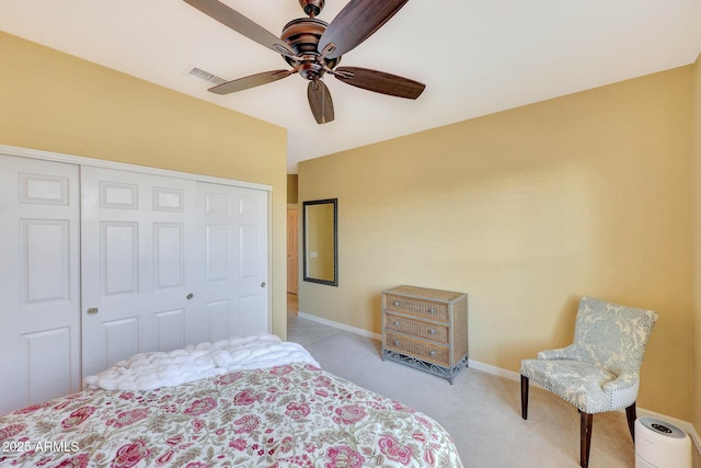 bedroom with light colored carpet, a closet, and ceiling fan