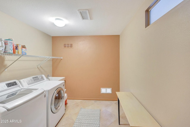 washroom with independent washer and dryer