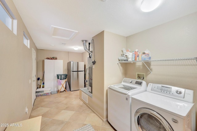 clothes washing area with washing machine and clothes dryer