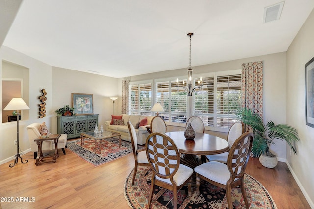 dining room featuring wood-type flooring and a notable chandelier