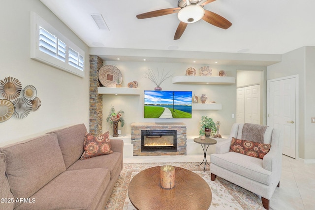 living room featuring ceiling fan, light tile patterned floors, and a fireplace