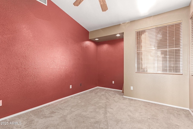 carpeted spare room with ceiling fan