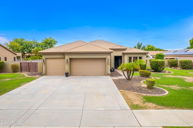 prairie-style home with a garage and a front yard