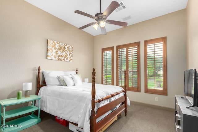 bedroom with ceiling fan and light colored carpet