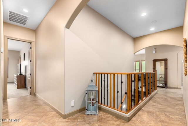 hall featuring light tile patterned floors