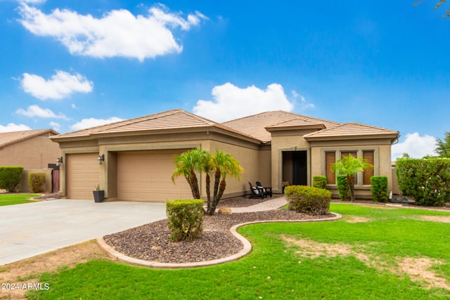 prairie-style home with a front yard and a garage