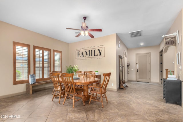 tiled dining area featuring ceiling fan