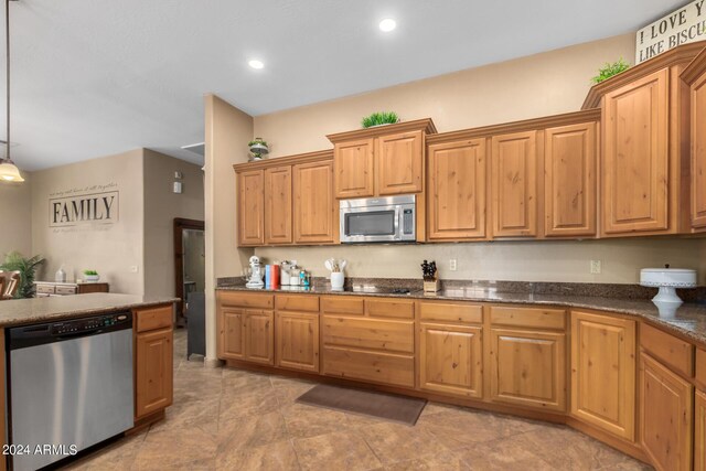 kitchen with dishwasher, ceiling fan with notable chandelier, a kitchen island with sink, and sink