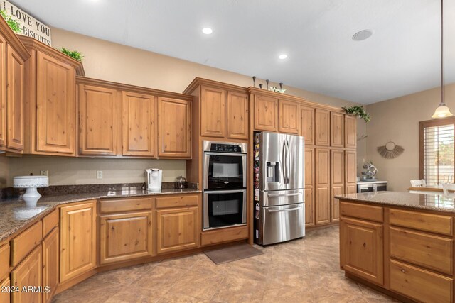 kitchen with appliances with stainless steel finishes and hanging light fixtures