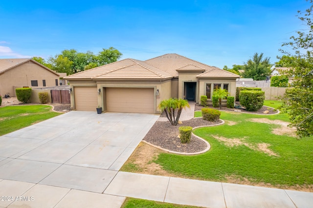 view of front of property with a garage and a front lawn