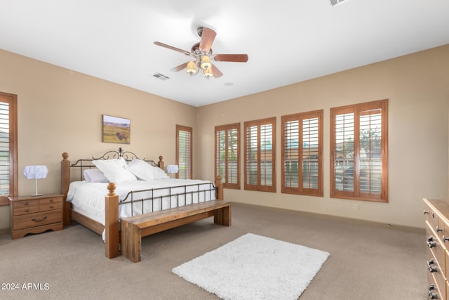 bedroom with light carpet and ceiling fan