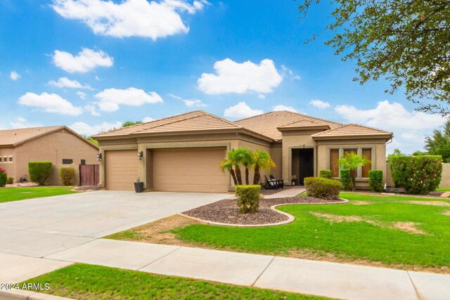 view of front facade with a garage and a front lawn