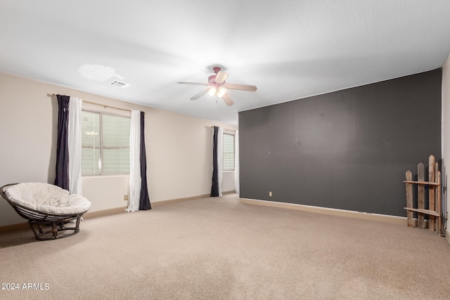 empty room with ceiling fan and light colored carpet