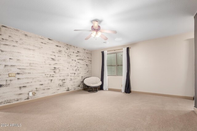 interior space with ceiling fan and carpet flooring