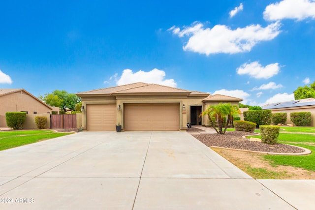 view of front of house with a front yard and a garage