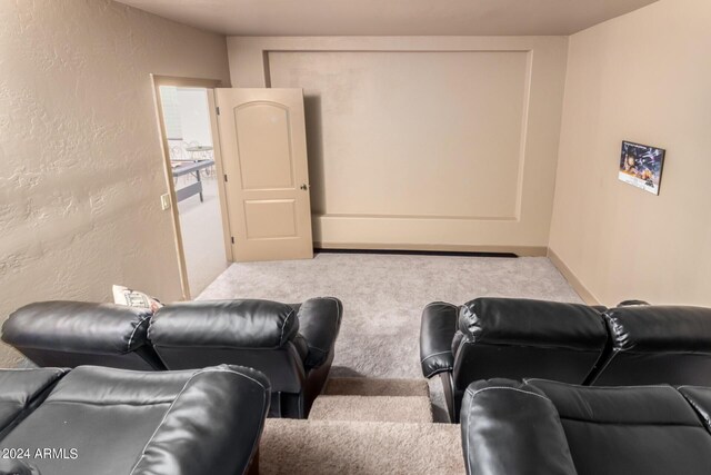 cinema featuring a textured ceiling and carpet flooring