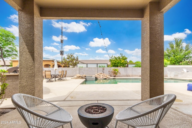 view of patio with a fenced in pool and an outdoor fire pit