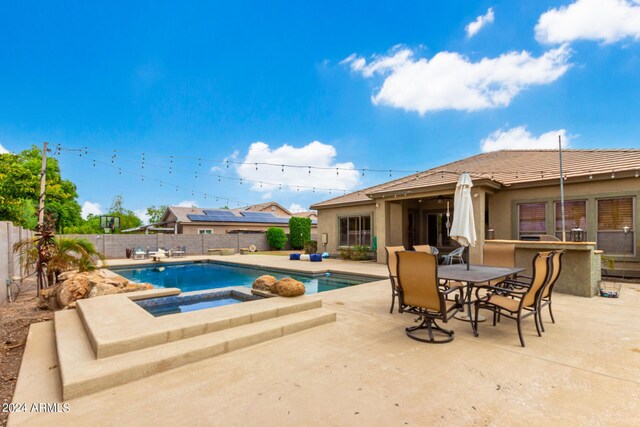 view of pool featuring an in ground hot tub and a patio