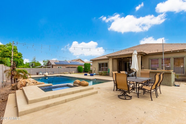 view of swimming pool with an in ground hot tub and a patio area