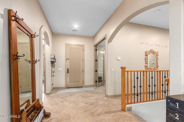 hall featuring an inviting chandelier