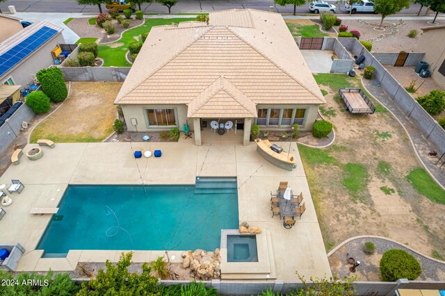 view of pool with a diving board and a patio area