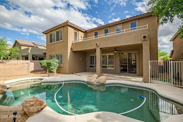 3054 W Eagle Claw Dr, Phoenix, AZ 85086 - back of property with stucco siding, a balcony, fence, a patio area, and a ceiling fan