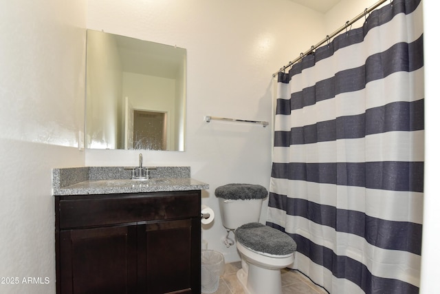 bathroom featuring tile patterned flooring, vanity, toilet, and curtained shower