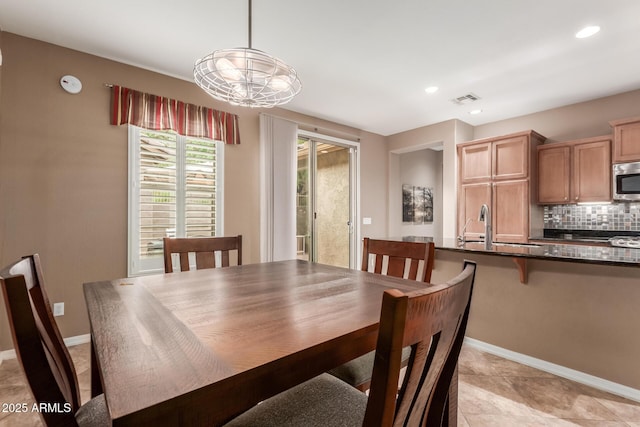 dining area with baseboards and recessed lighting