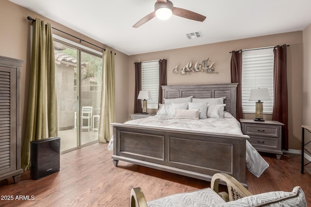 bedroom featuring access to outside, wood finished floors, and ceiling fan