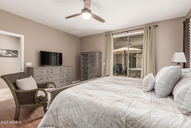 bedroom with wood finished floors, access to exterior, and a ceiling fan