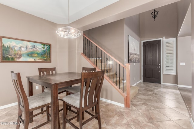 dining area with stairway, a chandelier, baseboards, and light tile patterned flooring