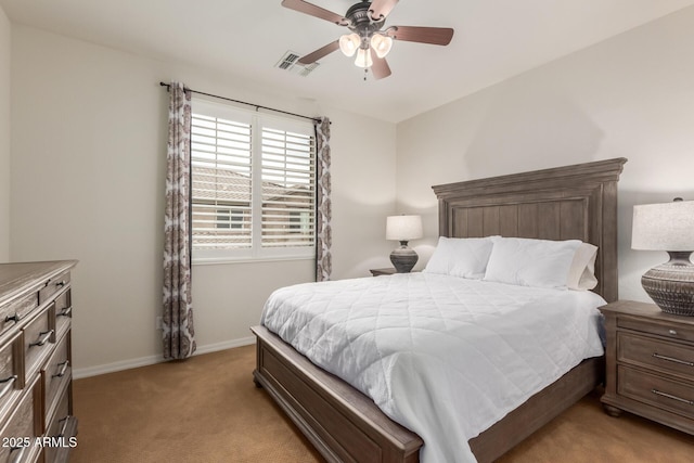 bedroom with light carpet, baseboards, and a ceiling fan