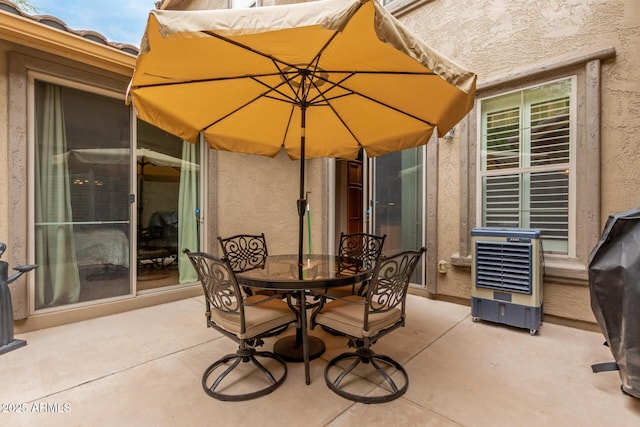 view of patio / terrace featuring outdoor dining area, heating unit, and area for grilling