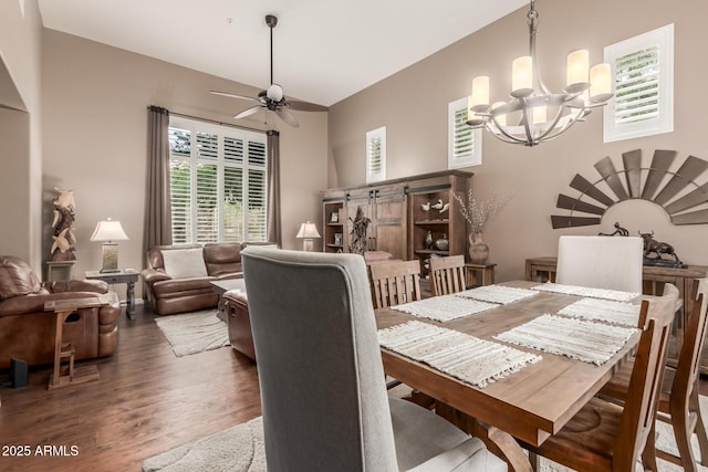 dining space with a chandelier, wood finished floors, and a ceiling fan
