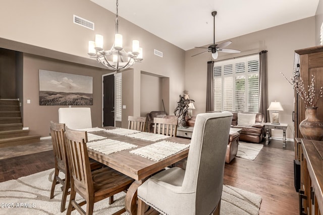 dining area with a chandelier, wood finished floors, stairs, ceiling fan, and baseboards