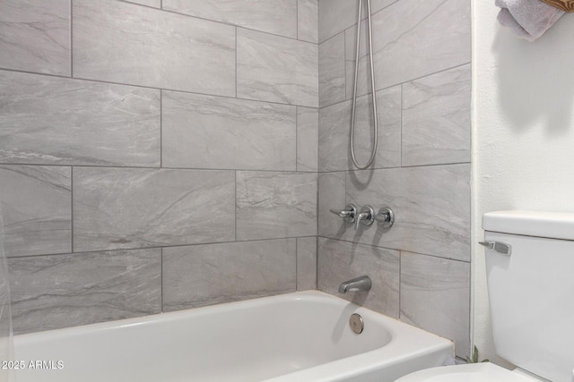 bathroom featuring shower / bath combination and toilet