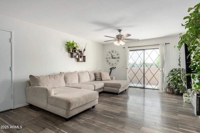 living area with ceiling fan and dark wood-style flooring