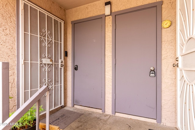 view of exterior entry featuring stucco siding