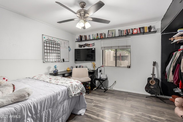 bedroom with ceiling fan and wood finished floors