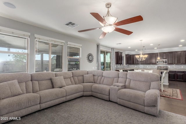 living room featuring a chandelier, recessed lighting, ceiling fan, and dark wood-style floors