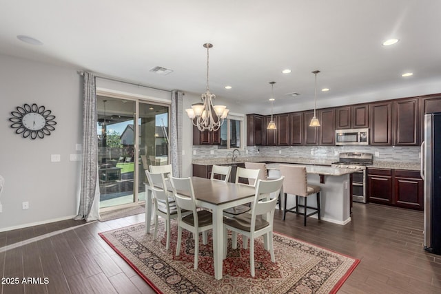 dining room featuring a chandelier, dark wood-style floors, recessed lighting, and baseboards