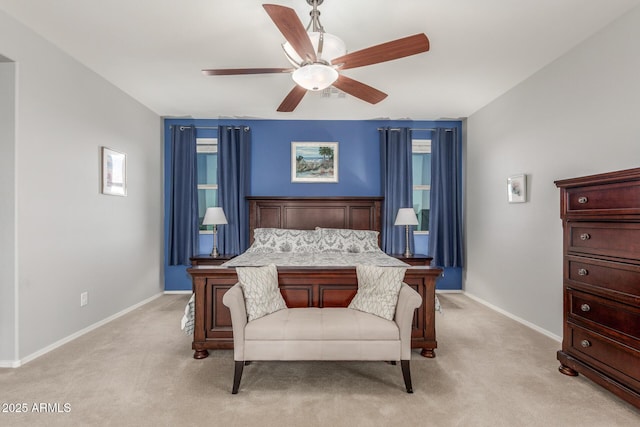 bedroom featuring light carpet, baseboards, and a ceiling fan